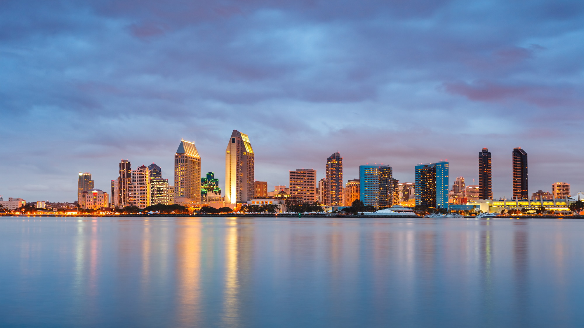 Couple sitting together on couch looking at laptop